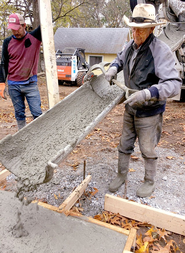 Westside Eagle Observer/JANELLE JESSEN Lindy Chamberlain, 87, of Gentry, pours concrete at a job in Siloam Springs.