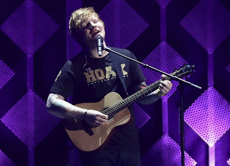 FILE - In this Dec. 1, 2017, file photo, Ed Sheeran performs at Jingle Ball at The Forum in Inglewood, Calif. The Grammys may have dissed Sheeran, but Spotify says he's the most streamed artist of the year. The streaming service announced Tuesday, Dec. 5, that Sheeran tops its 2017 list with 6.3 billion streams. (Photo by John Salangsang/Invision/AP, File)
