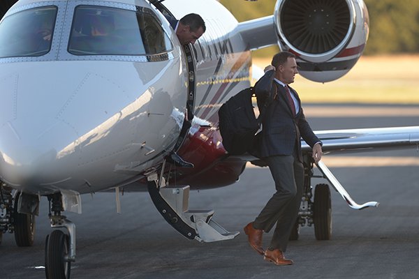 Arkansas football coach Chad Morris steps off a plane Wednesday, Dec. 6, 2017, at Drake Field in Fayetteville. 