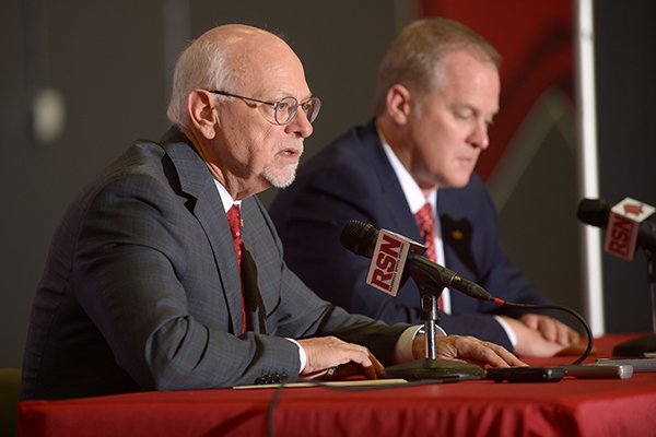 Joe Steinmetz (left), chancellor of the University of Arkansas, speaks Wednesday, Dec. 6, 2017, alongside Hunter Yurachek after Yurachek was introduced as the new director of athletics at the University of Arkansas during a news conference in the Fowler Family Baseball and Track Indoor Training Center in Fayetteville.
