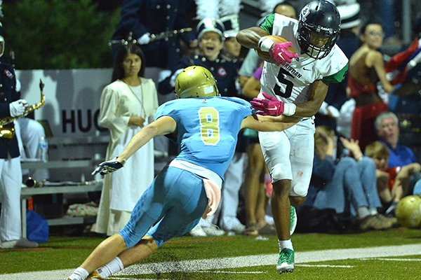 Little Rock Christian receiver Justice Hill (5) breaks a tackle attempt by Pulaski Academy's Luke Bratcher during a game Friday, Oct. 6, 2017, in Little Rock. 