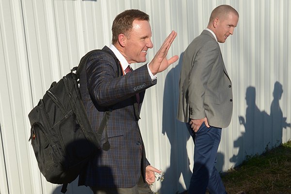 Arkansas football coach Chad Morris, left, waves to reporters after he landed at Drake Field in Fayetteville on Wednesday, Dec. 6, 2017. Morris was hired as the Razorbacks' 33rd football coach earlier in the day.