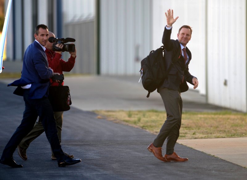 New Razorback coach Chad Morris waves as he arrives at Drake Field in Fayetteville on Wednesday, Dec. 6, 2017.