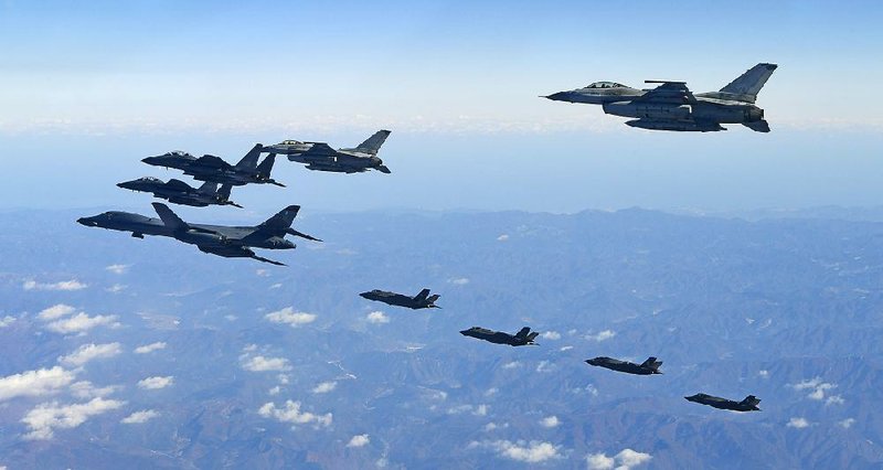 A U.S. Air Force B-1B bomber (left) and South Korean and U.S. fighter jets fly over the Korean Peninsula on Wednesday as part of a joint military exercise. 