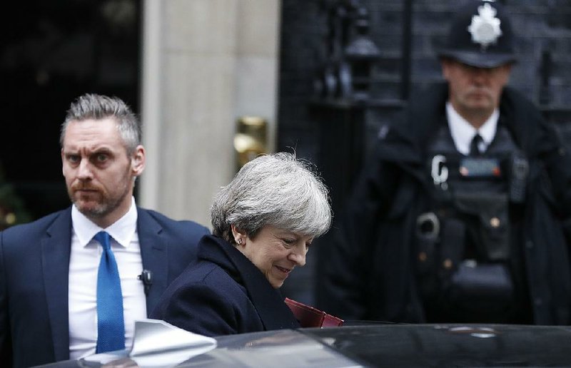 British Prime Minister Theresa May leaves 10 Downing St. in London on Wednesday under police guard to attend the weekly Prime Minister’s Questions in Parliament. 