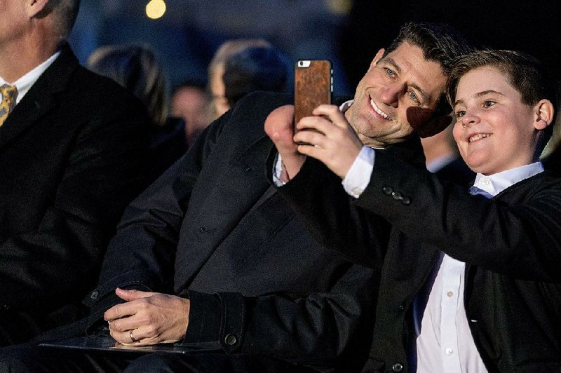 House Speaker Paul Ryan poses for a picture with Ridley Brandmayr of Bozeman, Mont., before the lighting of the Capitol Christmas tree Wednesday evening on Capitol Hill. 