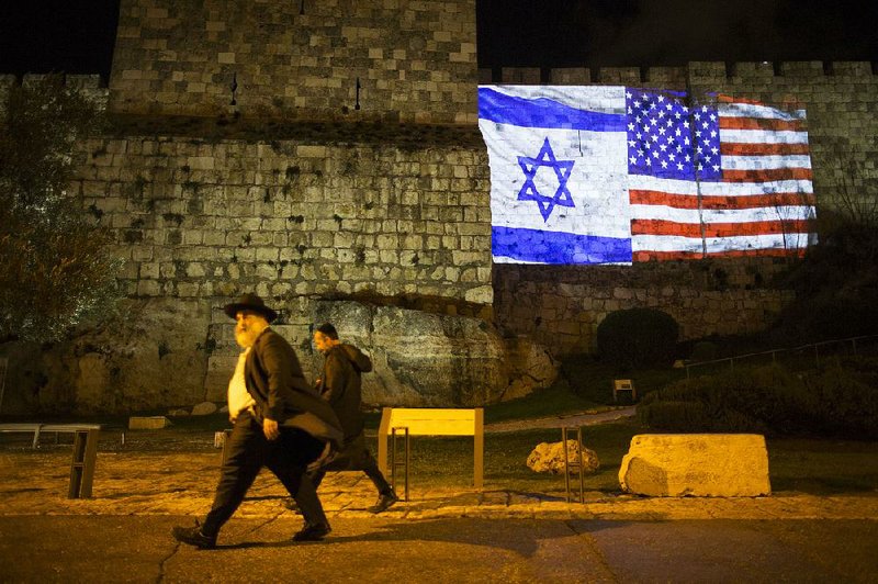 Projected images of the flags of Israel and the United States illuminate the walls of Jerusalem’s Old City on Wednesday evening.  
