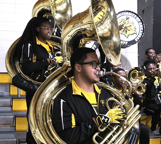 NATIONAL FLAVOR: University of Arkansas at Pine Bluff marching band members Taylor Alderson, left, and Caleb Patterson were among students to perform Wednesday at Trojan Fieldhouse for juniors and seniors at Hot Springs World Class High School. John Graham, UAPB director of bands, discussed the national representation of students in the Marching Musical Machine of the Mid-South. Alderson is from Chicago and Patterson is from Detroit.