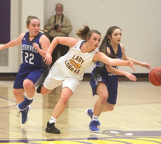 The Sentinel-Record/Richard Rasmussen COBRA SEAL: Fountain Lake's Hannah Ross fights for a loose ball Tuesday against Lexi Bassett and Taryn Anderson of Jessieville. The Lady Cobras shot 21-for-36 on free throws to seal a 44-41 win.