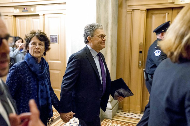 Associated Press/ANDREW HARNIK Sen. Al Franken, D-Minn., arrives with his wife Franni Bryson, left, on Capitol Hill in Washington, Thursday morning, Dec. 7, 2017.