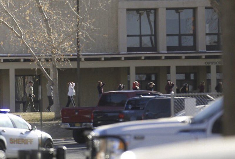 The Daily Times via AP/JON AUSTRIA Students are led out of Aztec High School after a shooting Thursday, Dec. 7, 2017, in Aztec, N.M. The school is in the Four Corners region and is near the Navajo Nation.