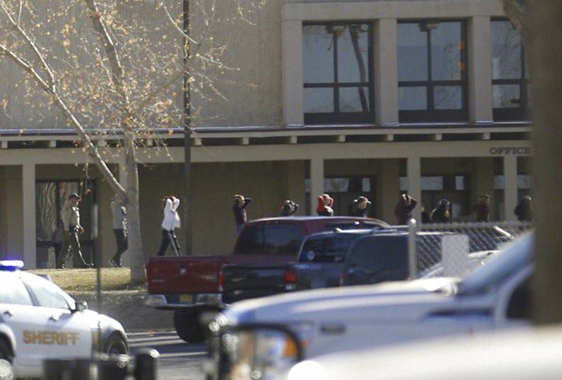 Students are led out of Aztec High School after a shooting Thursday, Dec. 7, 2017, in Aztec, N.M. 