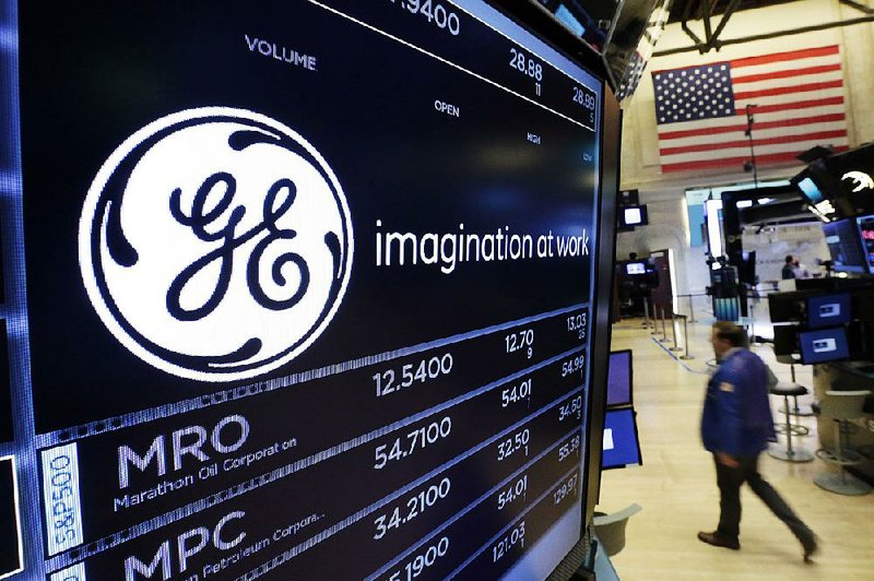 The General Electric logo is displayed at the New York Stock Exchange earlier this year. GE’s power division is shedding office and production jobs.