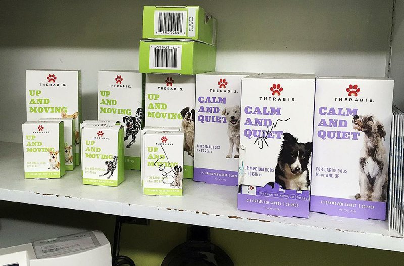 Marijuana extract products sit on display at a veterinary clinic in Bend, Ore. The effectiveness of such products to treat dogs’ joint pain and anxiety is unknown.