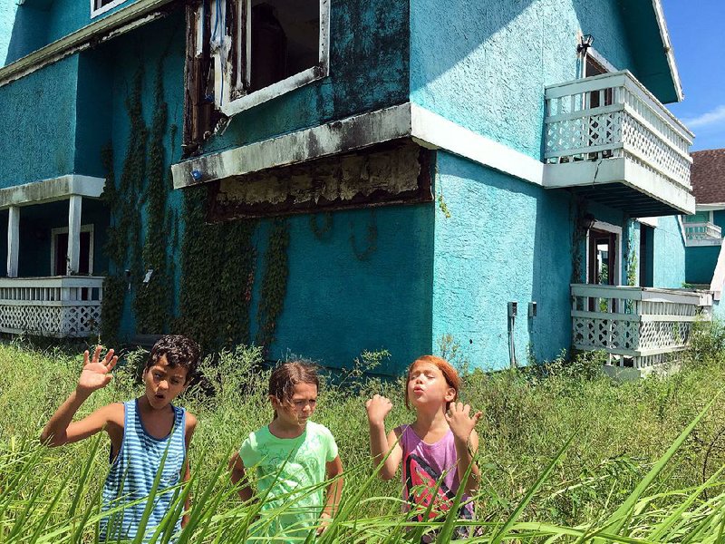 Scooty (Christopher Rivera), Moonee (Brooklynn Prince) and Jancey (Valeria Cotto) are largely without adult supervision in Sean Baker’s gritty The Florida Project.