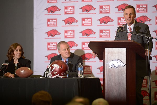 Arkansas football coach Chad Morris (far right) speaks while athletics director Hunter Yurachek (center) and former interim athletics director Julie Cromer Peoples look on during a news conference Thursday, Dec. 7, 2017, in Fayetteville. 