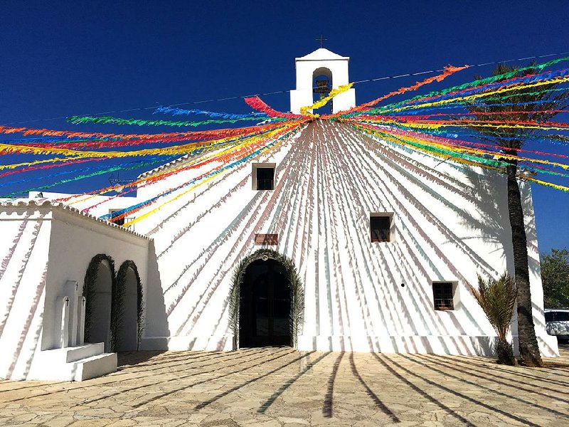 In the island’s north, a church in the quiet village of Sant Vincent de Sa Cala is decorated with colorful ribbons. While it has a reputation as party central, Ibiza offers a quiet, attractive escape.