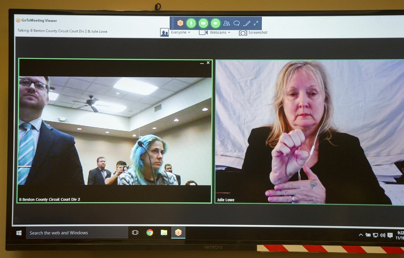 Julie Lowe, American Sign Language interpreter, signs for a client Nov. 16 at the Benton County Courthouse Annex in Bentonville. The court provides sign language and Spanish interpreters.