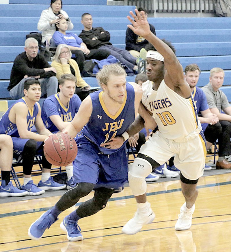 Photo submitted John Brown junior Jake Caudle drives the lane Tuesday against Central Christian (Kan.) in McPherson, Kan.