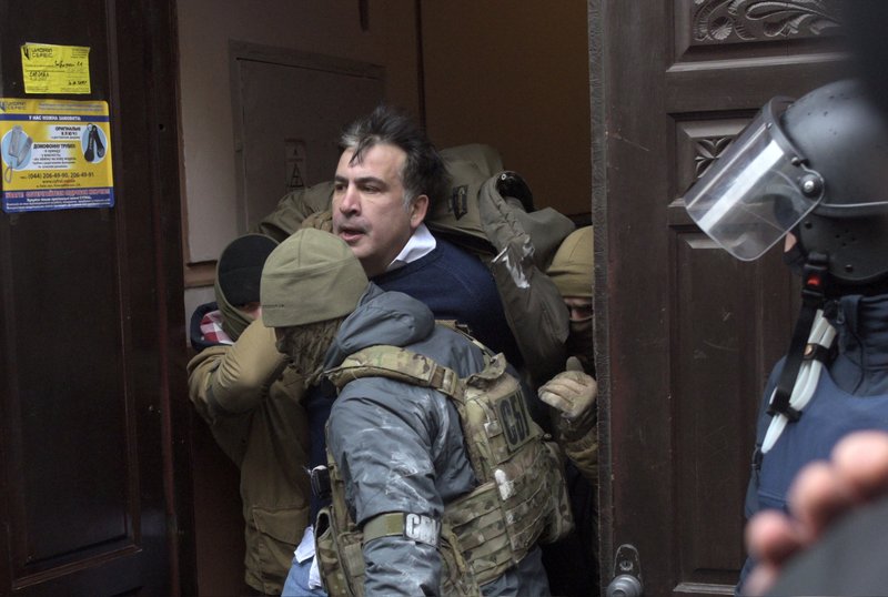 The Ukrainian Security Service officers detain Mikheil Saakashvili at the entrance of his house in Kiev, Ukraine, Tuesday, Dec. 5, 2017. Ukraine's prosecutor-general announced late Friday, Dec. 8, 2017, that opposition figure Mikheil Saakashvili has been arrested. (AP Photo/Evgeniy Maloletka)