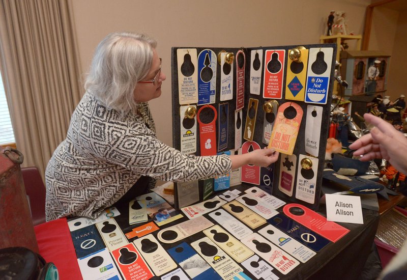 Alison Alison of Fayetteville talks to guests about her collection of ‘Do not disturb’ signs from hotels she has visited during the 2017 Cabin Fever Reliever open house at the Shiloh Museum of Ozark History in Springdale. The 2018 event is set for Jan. 13.