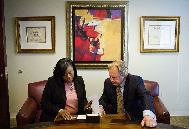 Sharonda Fields (left), who said she was abused while working at a Georgia restaurant last year, talks with her attorney Brad Dozier in his office in Atlanta last Monday.