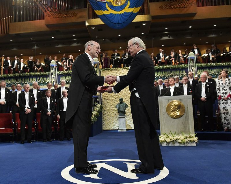 Michael Rosbash, laureate in physiology or medicine, receives his Nobel Prize from King Carl Gustaf of Sweden (right) during the Nobel award ceremony in Stockholm on Sunday.
