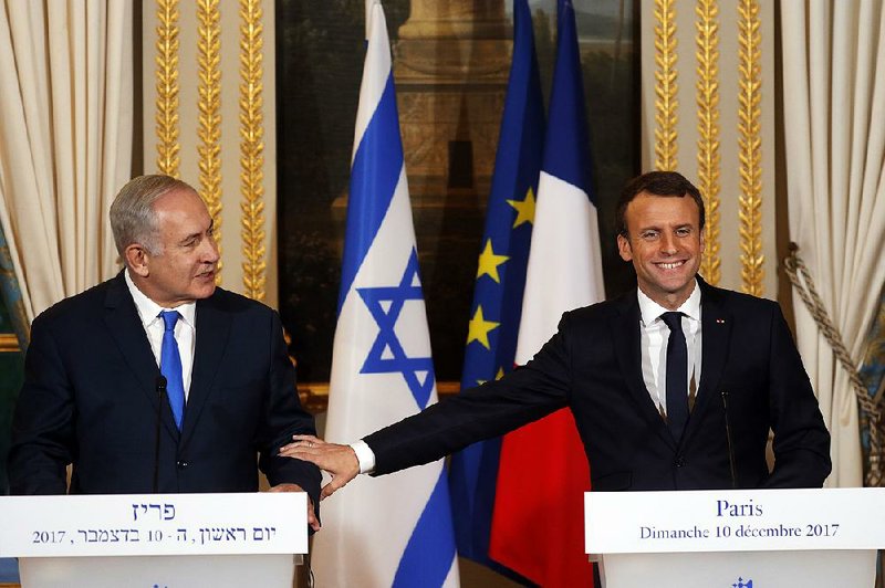French President Emmanuel Macron (right) and Israeli Prime Minister Benjamin Netanyahu attend a news conference after a meeting Sunday at the Elysee Palace in Paris.