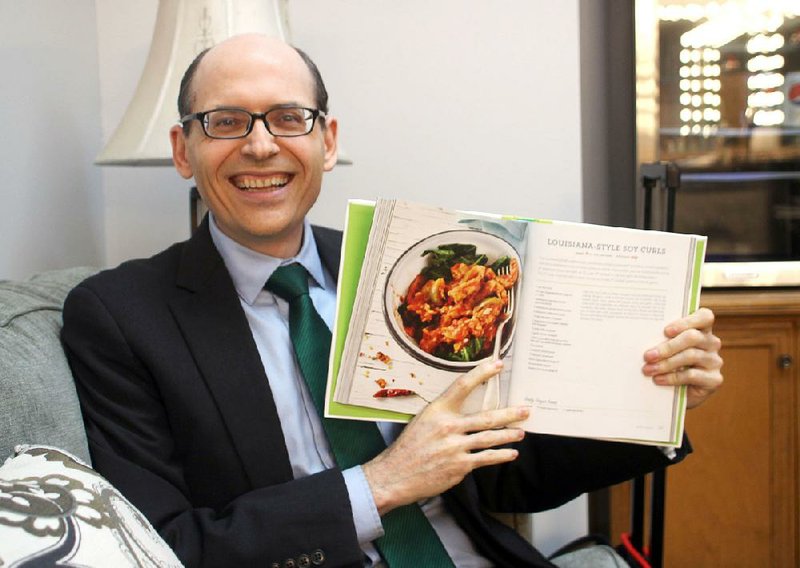 In a waiting  room at AETN  in Conway, Dr. Michael Greger holds a copy of The How Not to Die Cookbook, which was released by Flatiron Books last Tuesday.