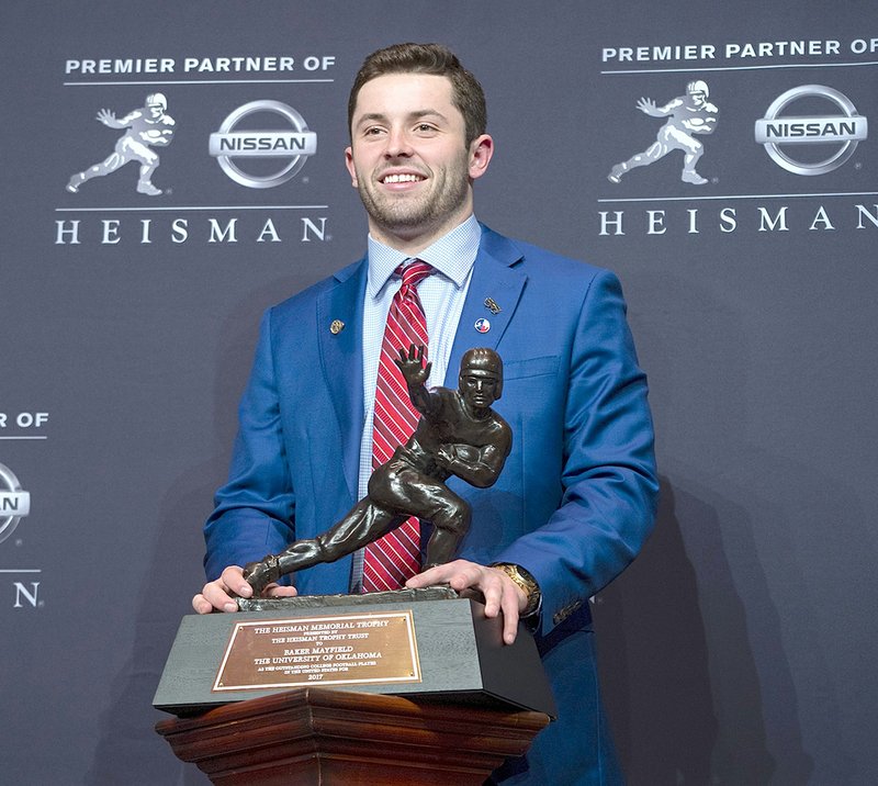 The Associated Press TROPHY WINNER: Oklahoma Sooner quarterback Baker Mayfield celebrated Saturday in New York after being awarded the Heisman Trophy. Mayfield received the Burlsworth Trophy, presented annually to college football's most outstanding player who began their career as a walk-on, in the previous two seasons.