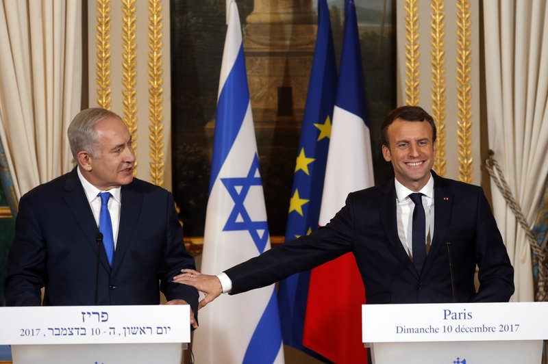 French President Emmanuel Macron, right, and Israeli Prime Minister Benjamin Netanyahu attend a press conference after a meeting at the Elysee Palace in Paris, Sunday, Dec.10, 2017. French President Emmanuel Macron &quot;firmly and clearly&quot; condemns all kinds of attacks against Israel in recent hours and days and reaffirmed his &quot;disapproval&quot; of U.S. President Donald Trump's move to recognize Jerusalem as the capital of Israel. (Philippe Wojazer/Pool via AP)