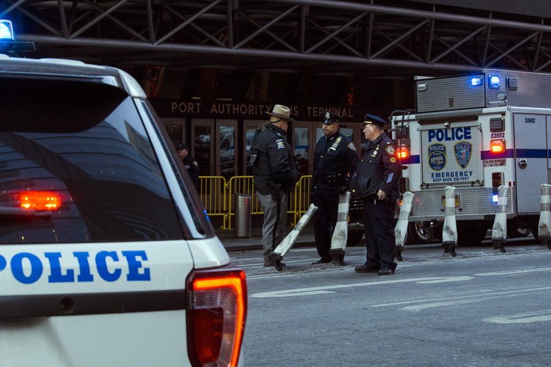 Police stand guard in front of the Port Authority Bus Terminal near New York’s Times Square following an explosion on Monday, Dec. 11, 2017. Police say the explosion happened in an underground passageway under 42nd Street between 7th and 8th Avenues. (AP Photo/Andres Kudacki)
