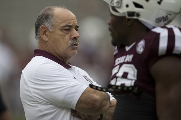 Texas A&M defensive coordinator John Chavis talks with Texas A&M linebacker Keeath Magee II (56) before the start of an NCAA college football game against Auburn on Saturday, Nov. 4, 2017, in College Station, Texas. (AP Photo/Sam Craft)
