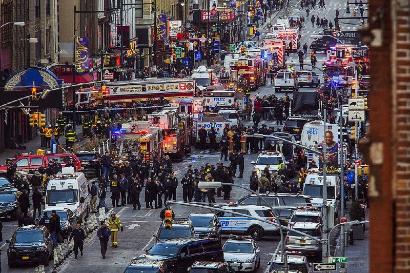 Law enforcement officials work after an explosion Monday near New York’s Times Square.