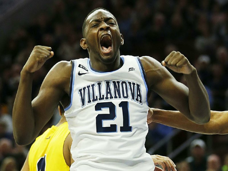 Villanova forward Dhamir Cosby-Roundtree reacts after dunking during the first half Sunday against La Salle in Philadelphia. The Wildcats are the top-ranked team in the latest Associated Press men’s poll.