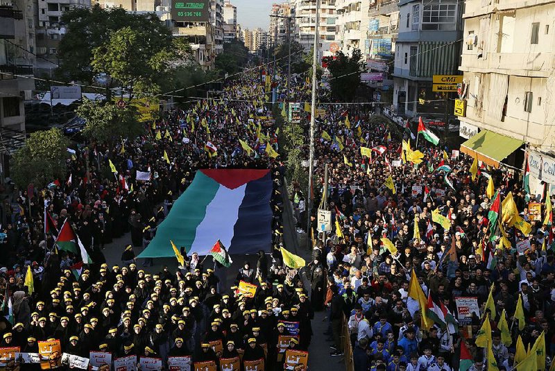 Lebanese and Palestinians march Monday in a street in a southern suburb of Beirut with a Palestinian flag in response to a call by Hezbbollah leader Sheikh Hassan Nasrallah to protest President Donald Trump’s recognition of Jerusalem as the capital of Israel.