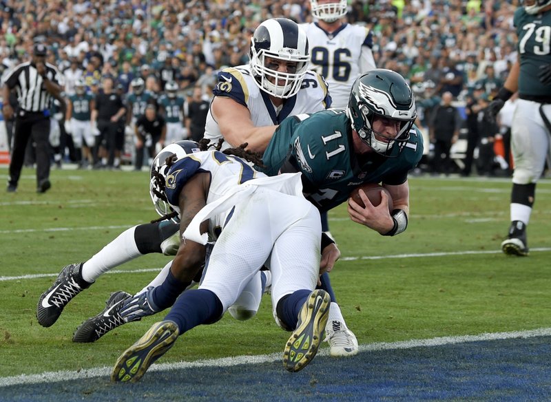 Philadelphia Eagles quarterback Carson Wentz gets tackles during the second half of an NFL football game against the Los Angeles Rams Sunday, Dec. 10, 2017, in Los Angeles. Wentz left the game shortly after the play and did not return to the game. 