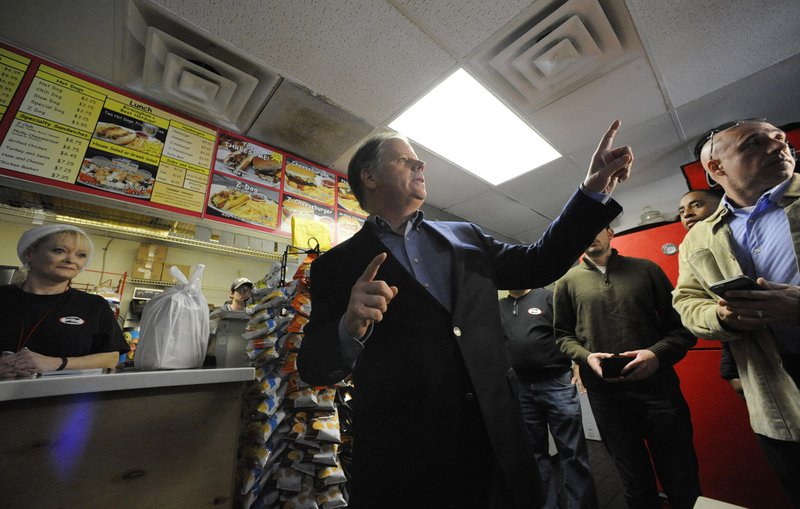 Democratic U.S. Senate candidate Doug Jones speaks to the media during a campaign stop at Chris Z's in Birmingham, Ala., on Monday, Dec. 11, 2017. Jones accused Republican nominee Roy Moore of hiding in the final days of the race. 