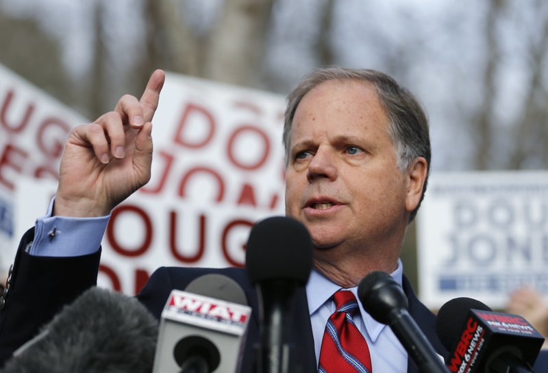 Democratic candidate for U.S. Senate Doug Jones speaks to reporters after casting his ballot Tuesday, Dec. 12, 2017, in Mountain Brook , Ala. Jones is facing Republican Roy Moore. (AP Photo/John Bazemore)

