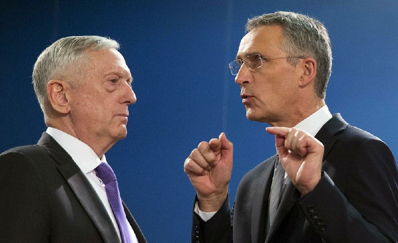 NATO Secretary-General Jens Stoltenberg (right), pictured in November with U.S. Defense Secretary James Mattis in Belgium, was approved Tuesday to head the alliance for another two years. 