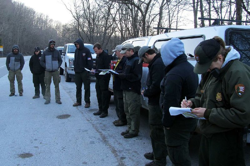 A crew receives a morning briefing Tuesday before deploying to monitor a wildfire near the Buffalo National River. The fire has been contained within 425 acres near Boxley Valley. 