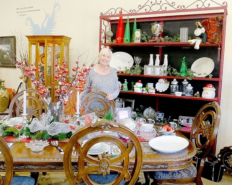 Lynn Atkins/The Weekly Vista Store manager Kristy Danna stands behind a table set for the holidays at Aurdrey's Resale Boutique. The store is filled with gently-used items, including furniture, housewares and clothing. It supports a nonprofit that helps pregnant women in crisis.