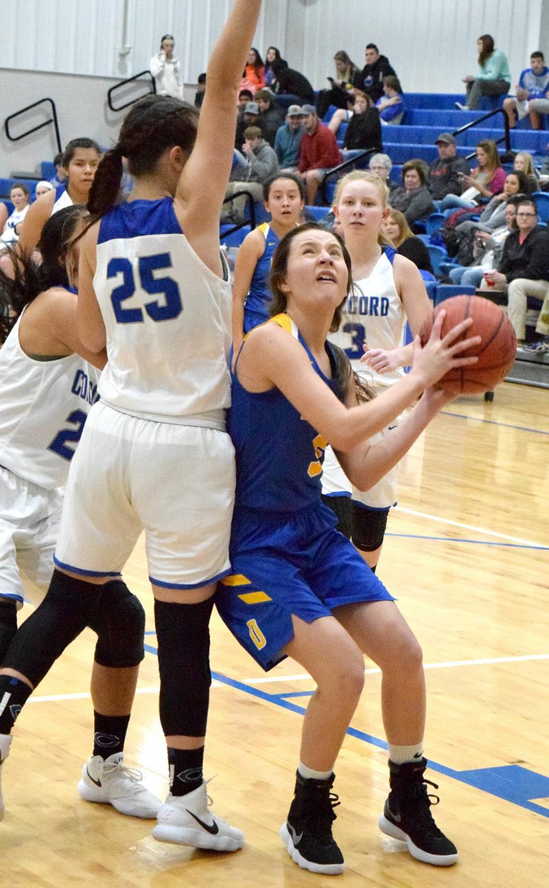 Westside Eagle Observer/MIKE ECKELS Surrounded by Lady Hornets, Decatur's Paige Vann looks for the basket for a shot during the third quarter of the Decatur-Colcord senior girls' basketball contest Dec. 7 in the gym at Colcord High School in Colcord, Okla.