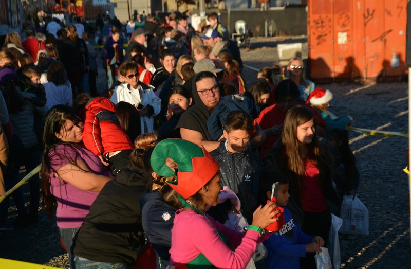 Mike Capshaw/Herald-Leader A large line formed for a chance to sit on Santa's lap during the Kansas City Southern's Holiday Express' stop in Siloam Springs on Sunday.