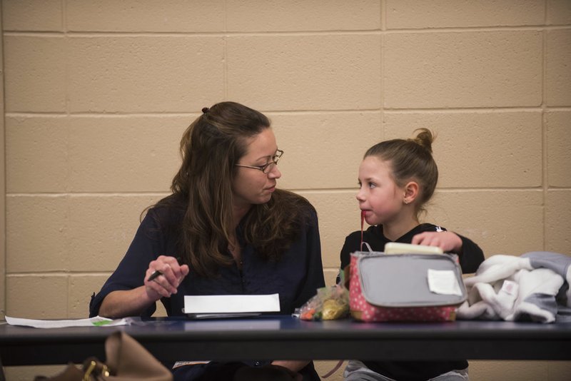 NWA Democrat-Gazette/SPENCER TIREY Hope Daniels (right) jokes Tuesday with her mother Sarah Daniels as they eat together at Sugar Creek Elementary School in Bentonville.