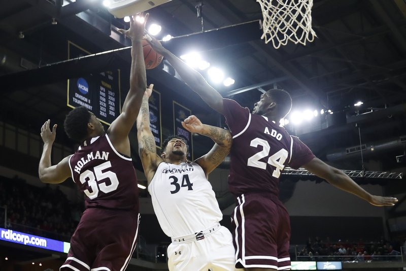 Mississippi State's Abdul Ado (24) blocks a shot by Cincinnati's Jarron Cumberland (34) in the first half of an NCAA college basketball game, Tuesday, Dec. 12, 2017, in Highland Heights, Ohio. (AP Photo/John Minchillo)