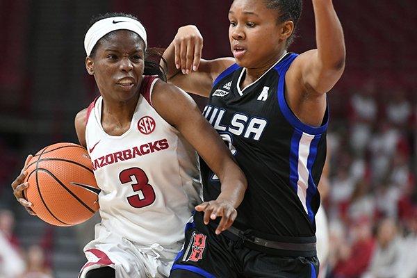 Arkansas’ Malica Monk (3) drives past Tulsa’s Erika Wakefield during Sunday’s game at Walton Arena in Fayetteville. Monk led all scorers with 14 points.