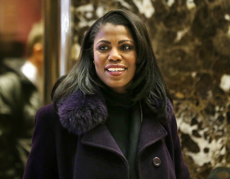 In this Dec. 13, 2016, file photo, Omarosa Manigault smiles at reporters as she walks through the lobby of Trump Tower in New York. 