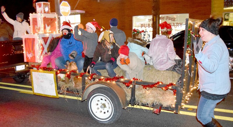 Westside Eagle Observer/MIKE ECKELS The Decatur 4H float makes its way through downtown Decatur during the annual Decatur Christmas Parade Dec. 8. The 4H entry took third place in the non-profit division of the float competition.