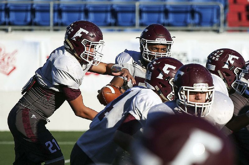 Foreman quarterback Kyren Batey (center, top) directs a play during the Gators’ workout Wednesday at War Memorial Stadium in Little Rock. Batey has rushed for 1,832 yards and 32 touchdowns on 138 carries entering Friday’s Class 2A championship game against Mount Ida. 